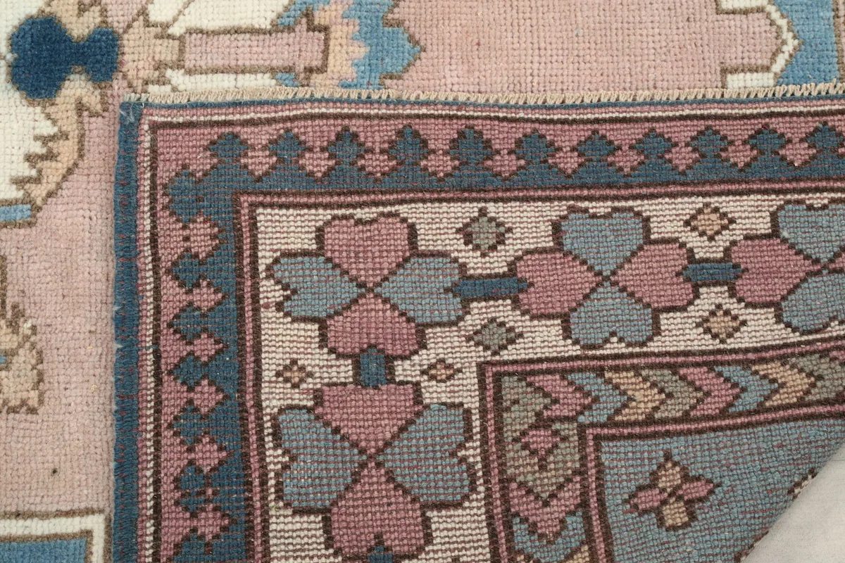 Close-up of the rug's folded corner, showing the tightly woven cotton foundation