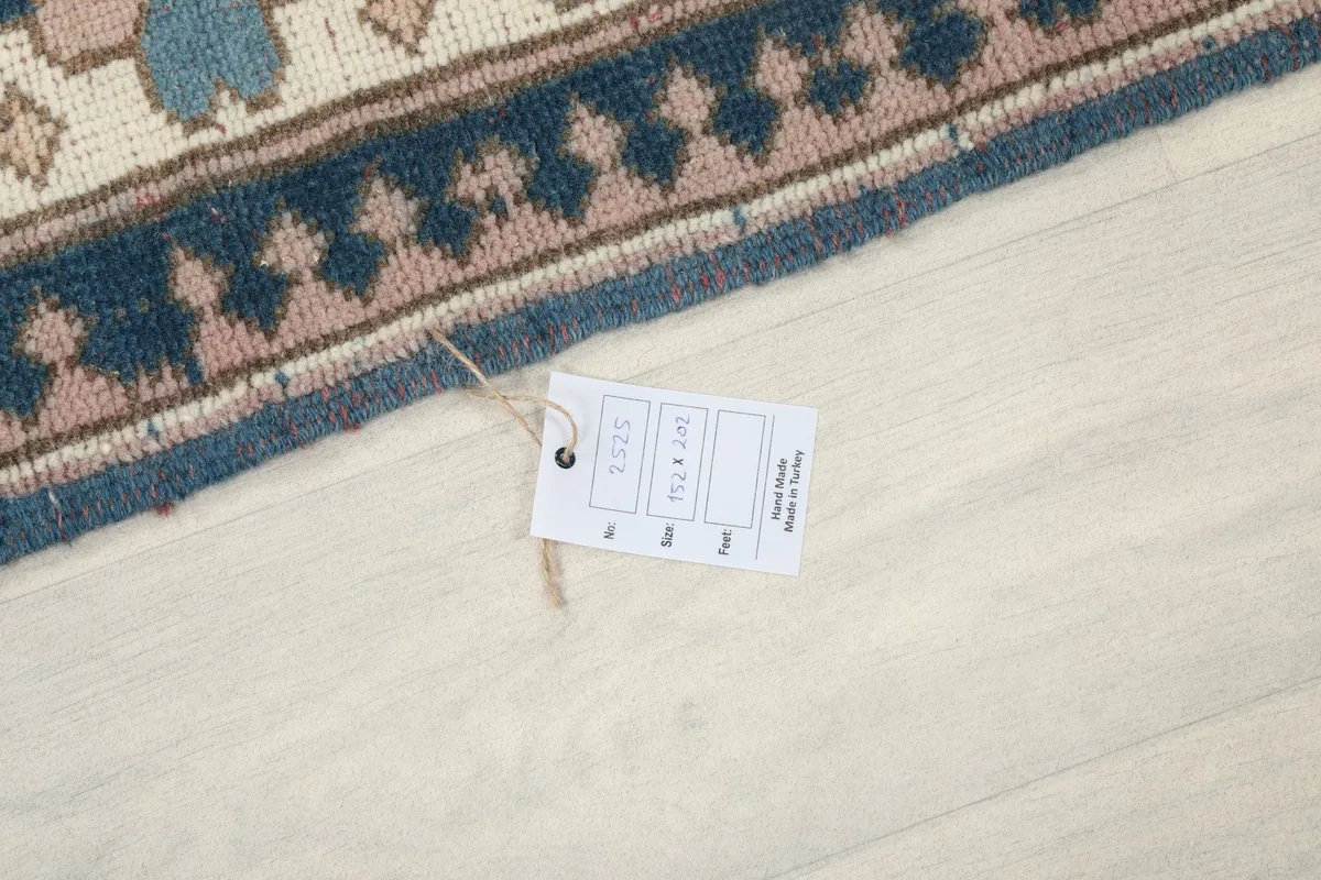 Close-up of the product tag attached to the rug's edge, showing details
