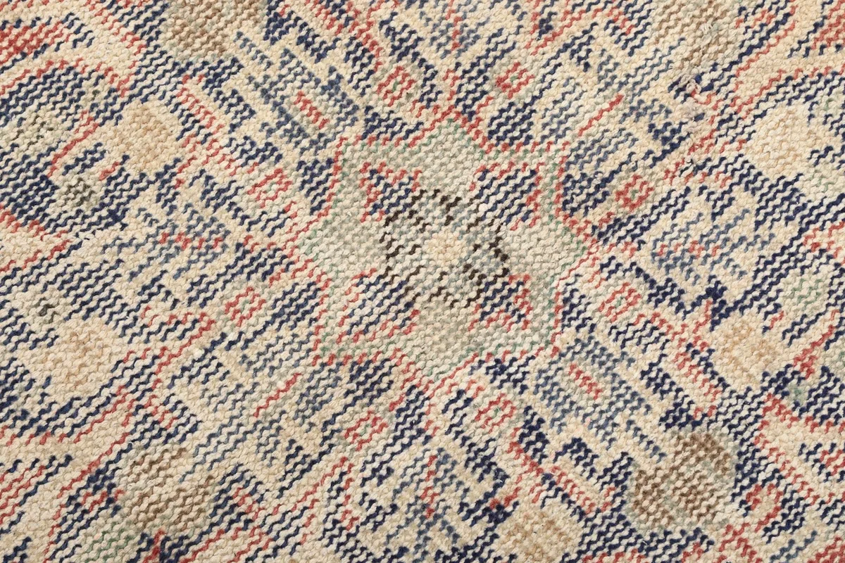 Close-up of the rug's hand-knotted cotton foundation and tight weave