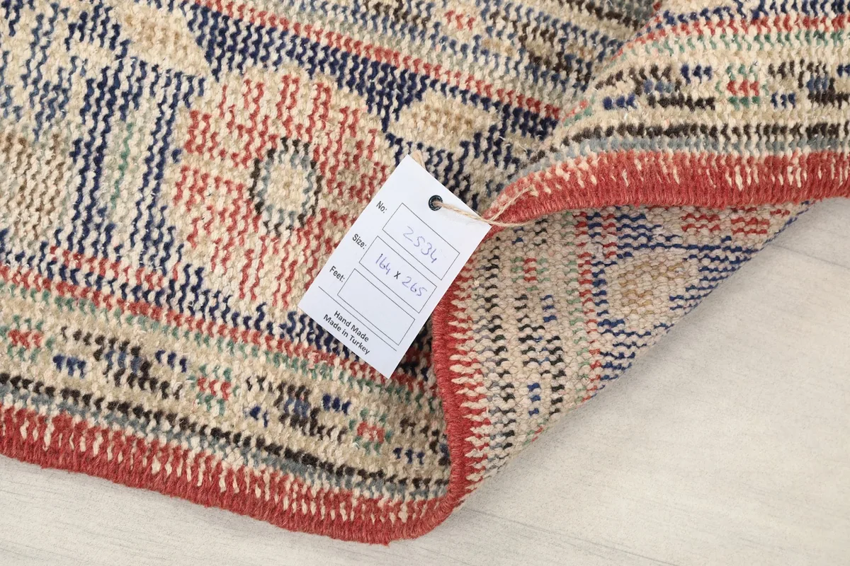 Close-up of the rug's reverse side with a tag indicating its origin and material