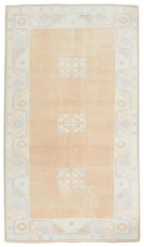 Full top view of the vintage tan Anatolian rug with geometric patterns and ivory border