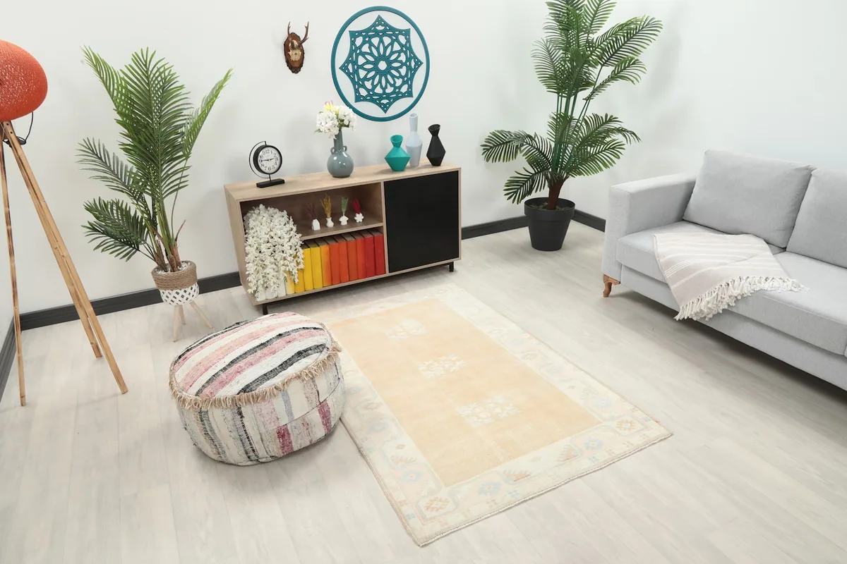Overhead view of the tan rug in a room setting, showing its placement relative to decor