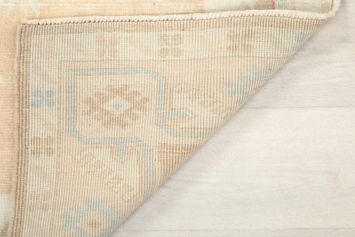 Another view of the rug corner folded, showing the reverse side and craftsmanship