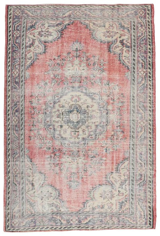 Full overhead view of a vintage rose medallion area rug with blue and beige accents
