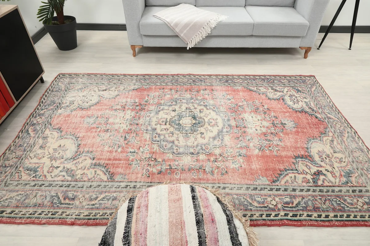 Frontal view of the rug in a living room, showcasing the medallion as a central element