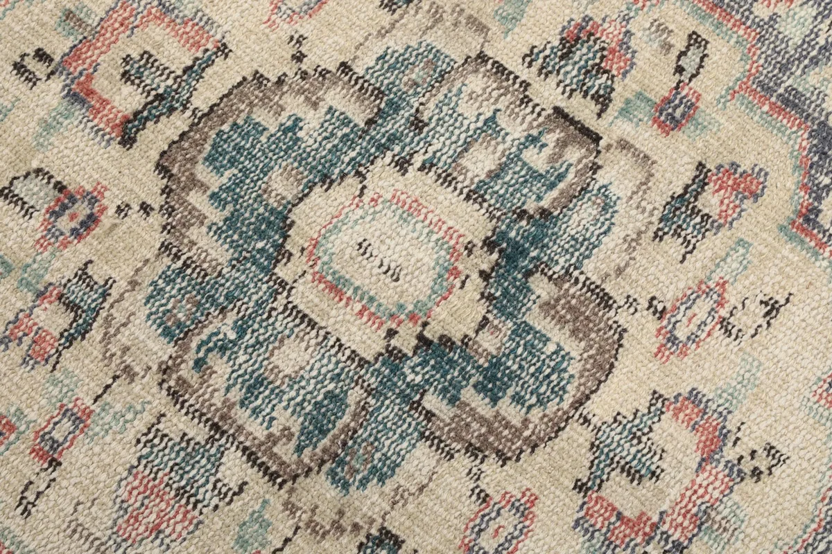 Macro detail of the hand-knotted wool pile, showing the texture and color variations