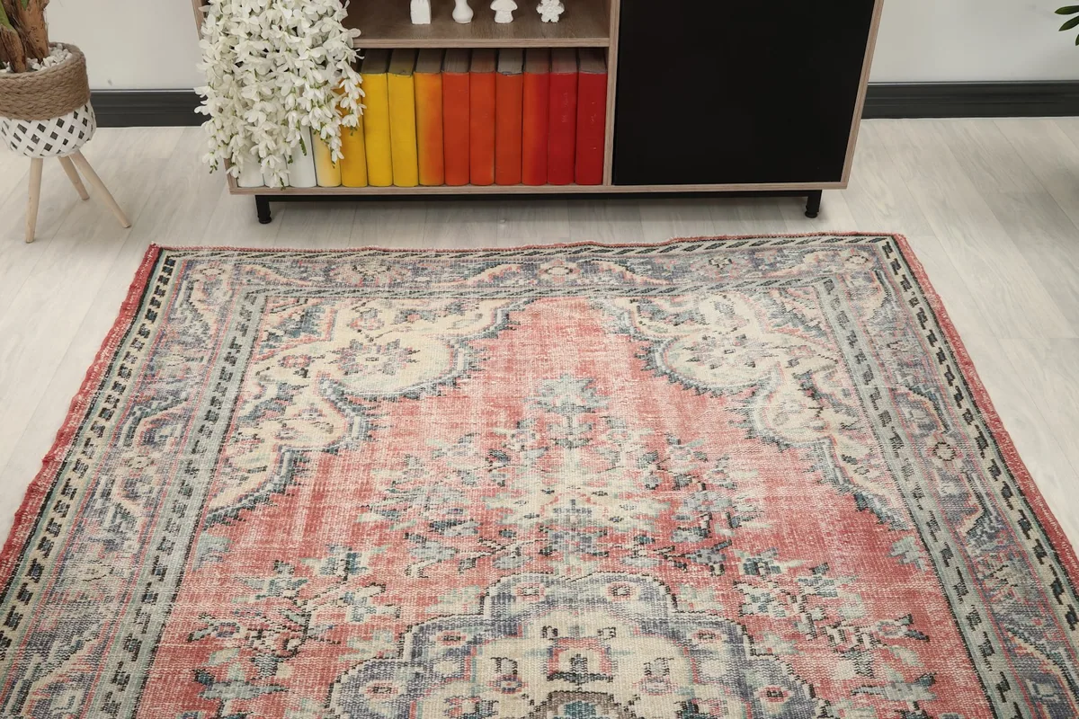 Overhead perspective of the rose rug from one end, showing the full design in a room