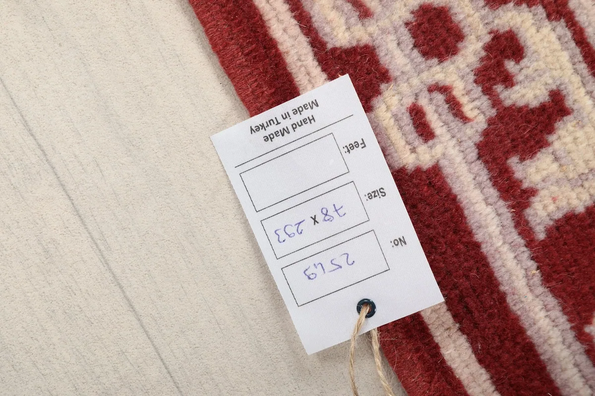 Close-up of the rug's label, displaying its origin as Hand Made in Turkey and size 78x293 cm.