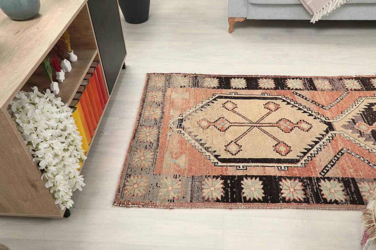 Angled view looking down the length of the runner rug towards a cabinet