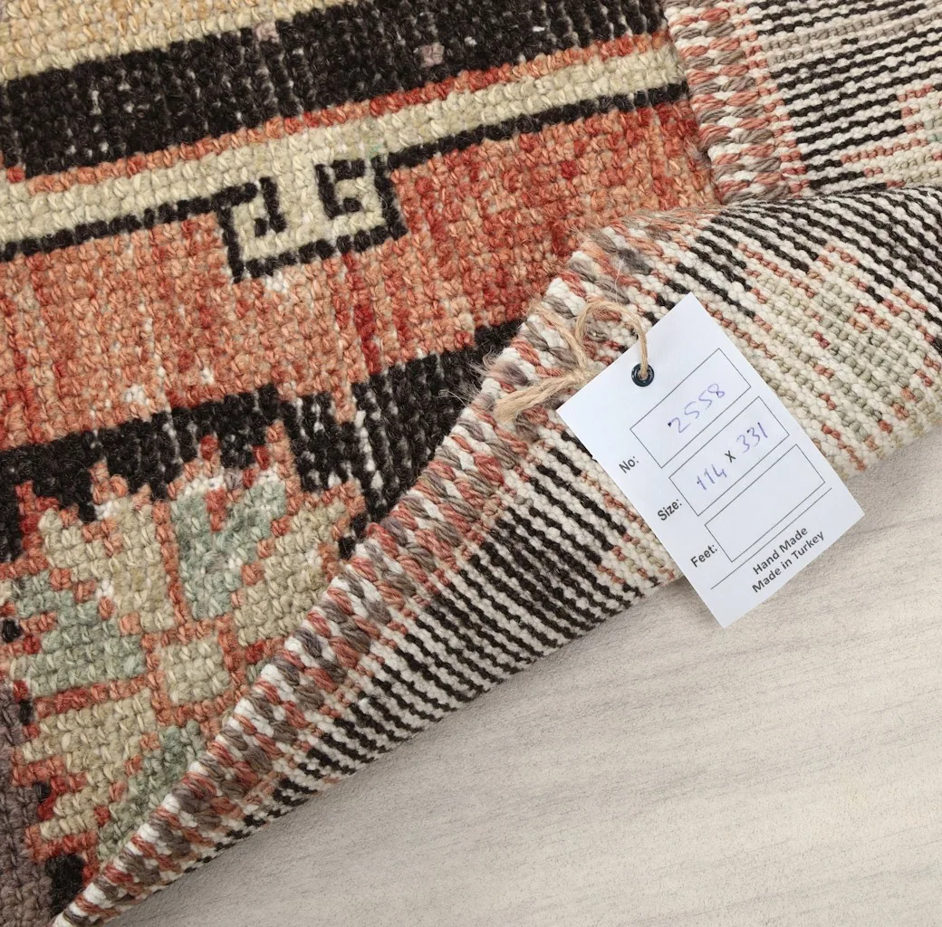 Close-up of the rug's back with a product tag showing dimensions and origin