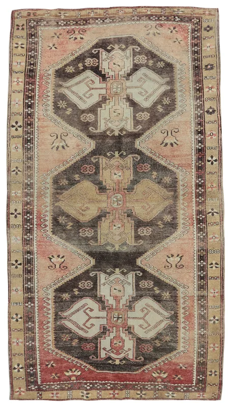Full top view of the vintage rose and charcoal geometric Anatolian area rug on a white background