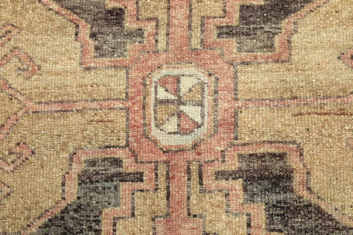 Texture detail of the hand-knotted wool pile, showing individual knots and low height