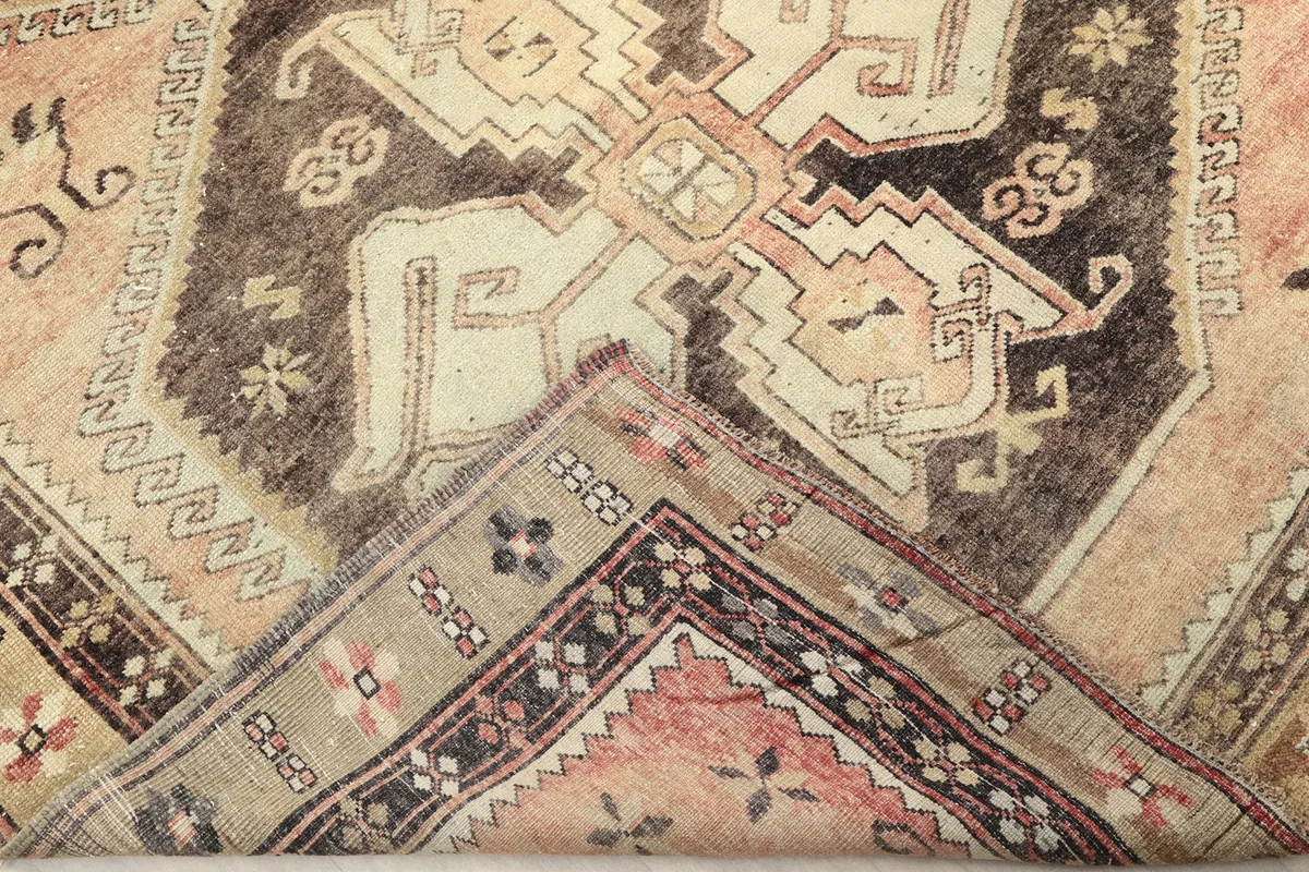 Folded corner of the rug revealing the cotton foundation and reverse side of the hand-knotted wool
