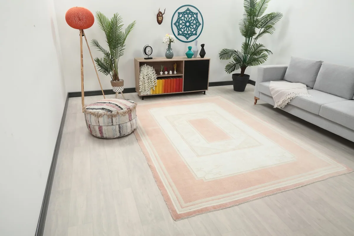 Angle view of the hand-knotted rug in a room, showing its full dimensions and color