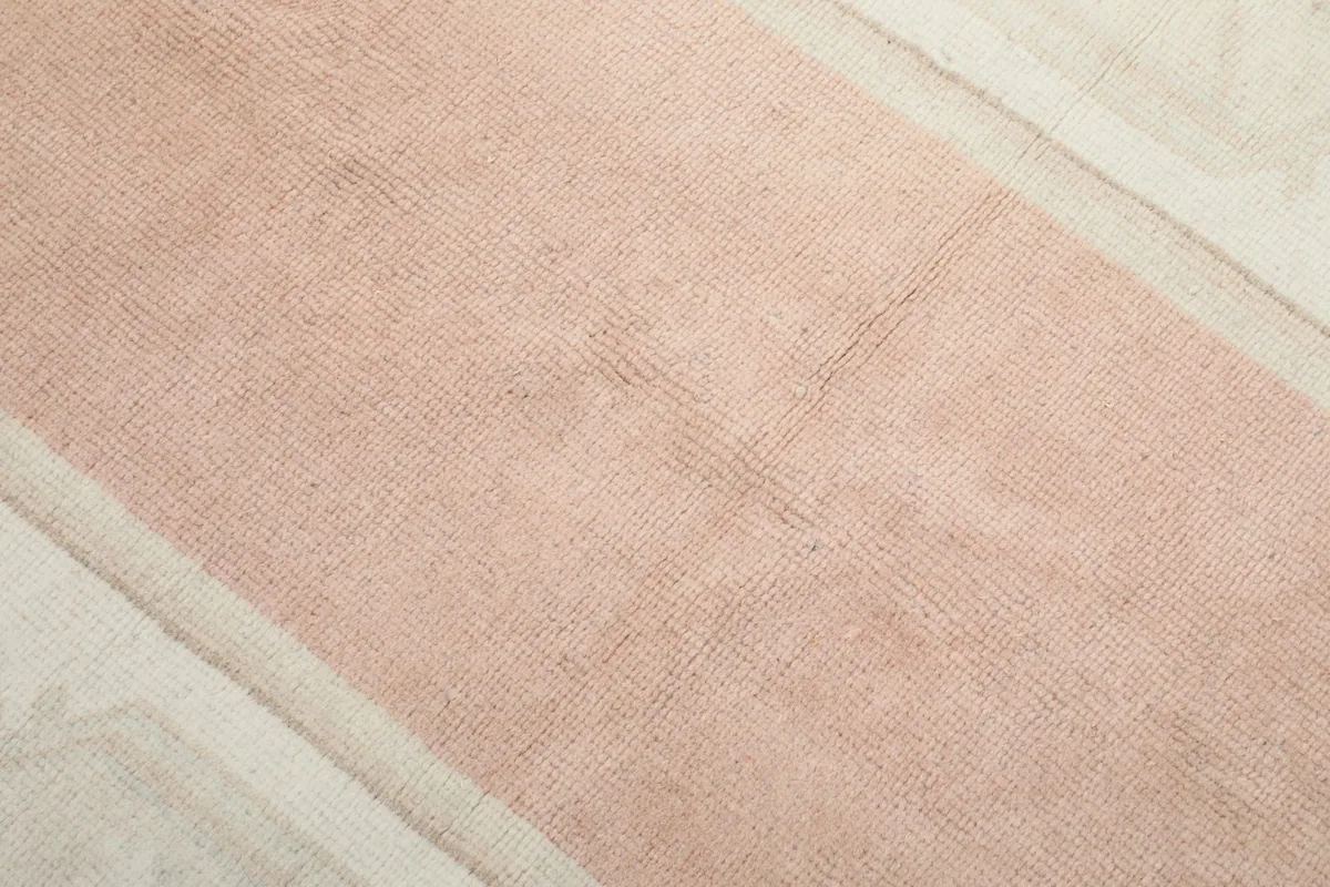 Close-up of the rug's low wool pile, showing texture and slight color variation