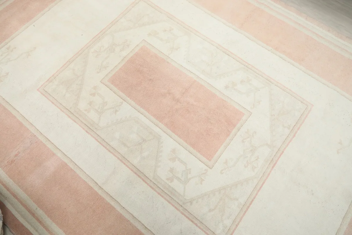 Overhead view focusing on the central pink rectangle and surrounding ivory patterns