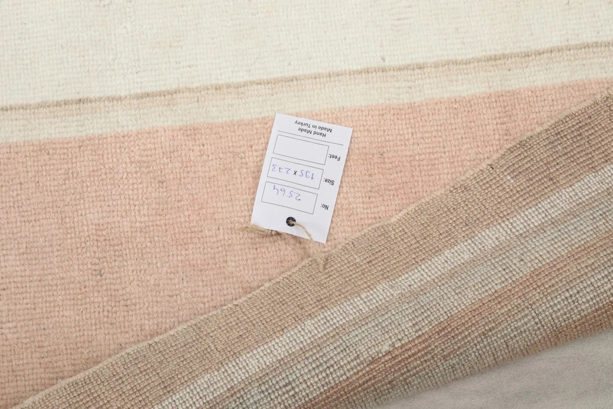 Close-up of the rug's reverse side with a label, indicating its origin and materials