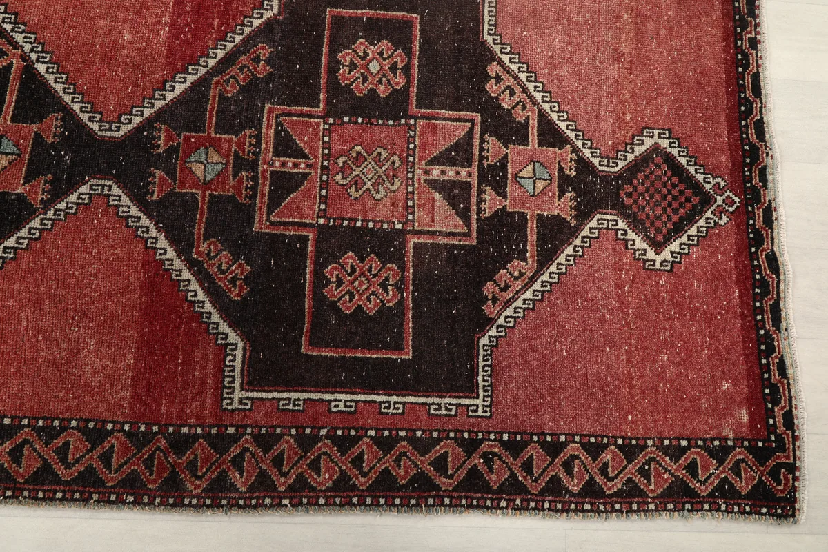 Close-up detail of the Rust Geometric Anatolian Runner's central black and rust geometric pattern.