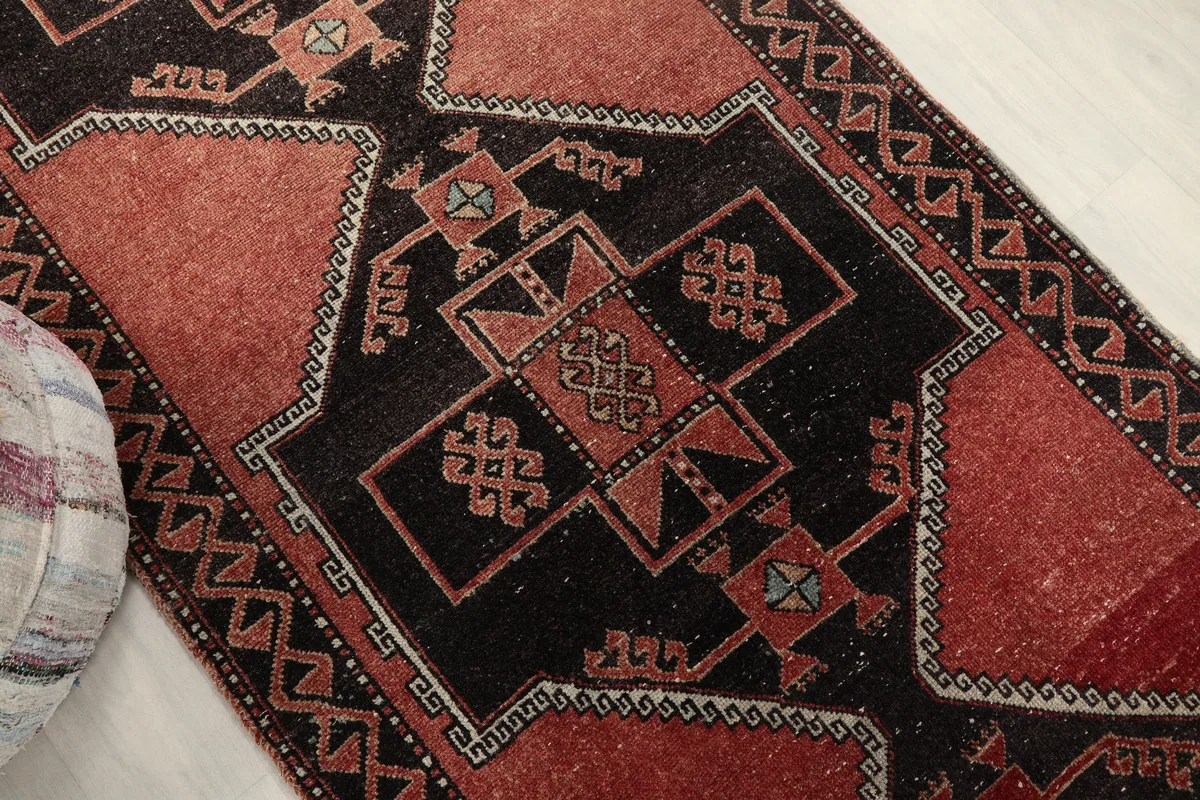Detail view of the Rust Geometric Anatolian Runner showing the intricate tribal motifs and color variations.
