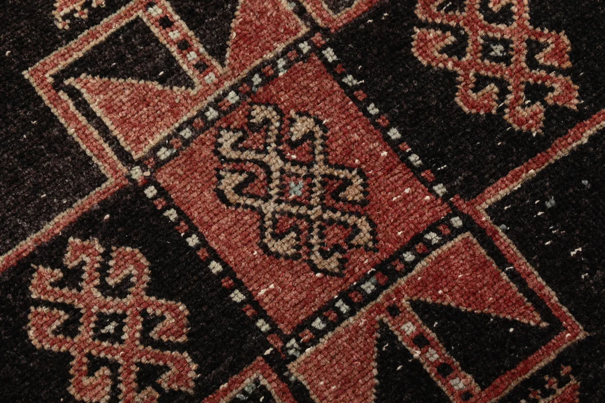Close-up of the Rust Geometric Anatolian Runner's low wool pile and knotting detail.