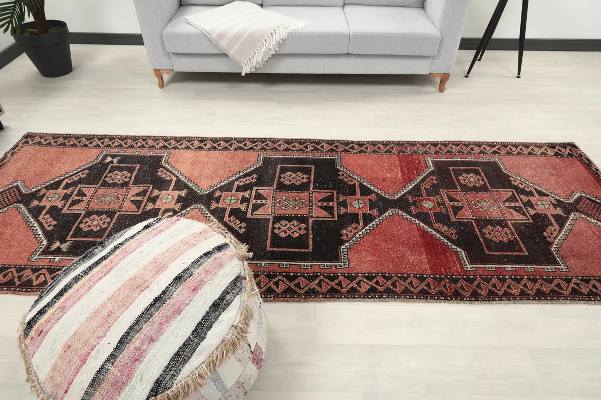 Rust Geometric Anatolian Runner in a full room shot, highlighting its appeal in a home setting.
