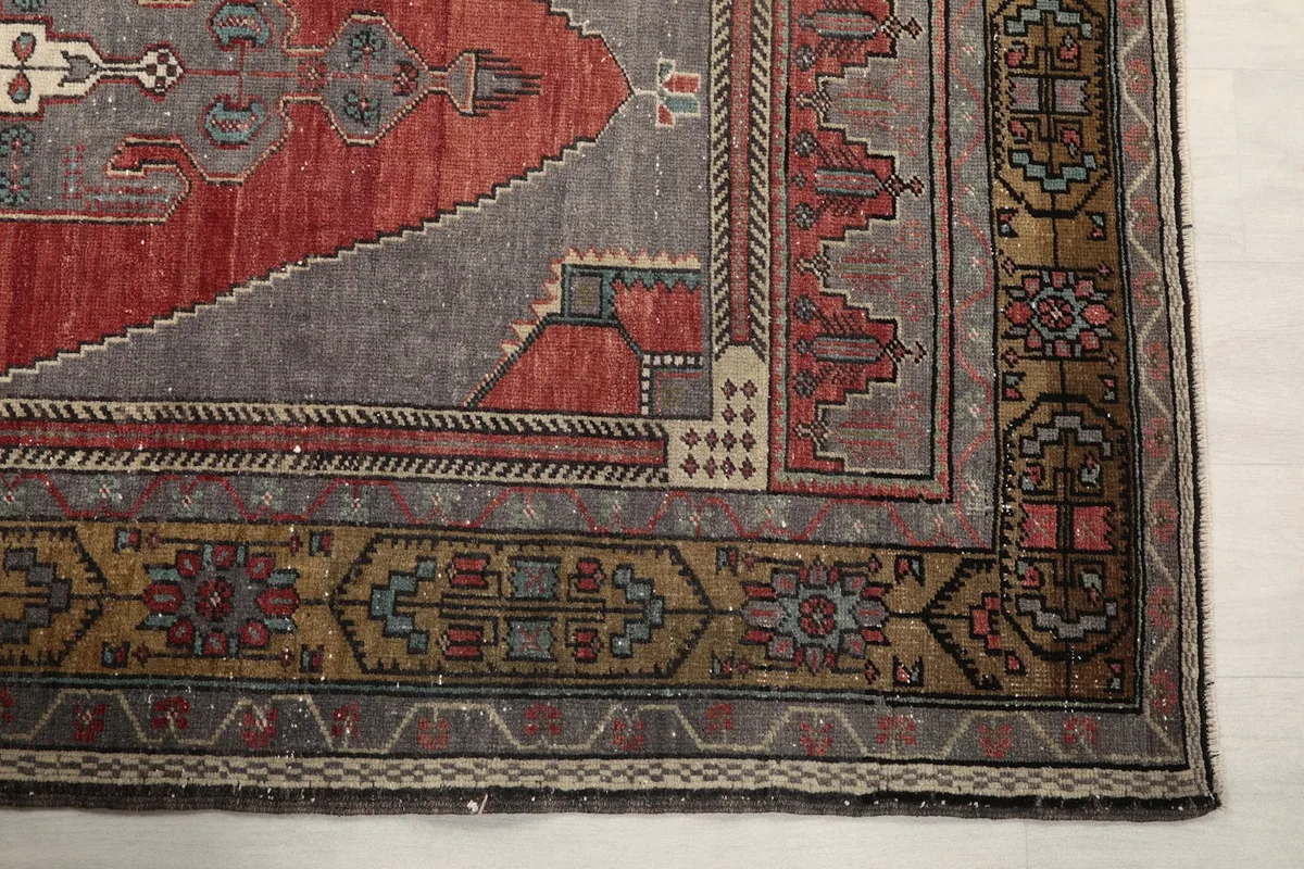 Detailed view of the rug's corner showing geometric patterns and border design