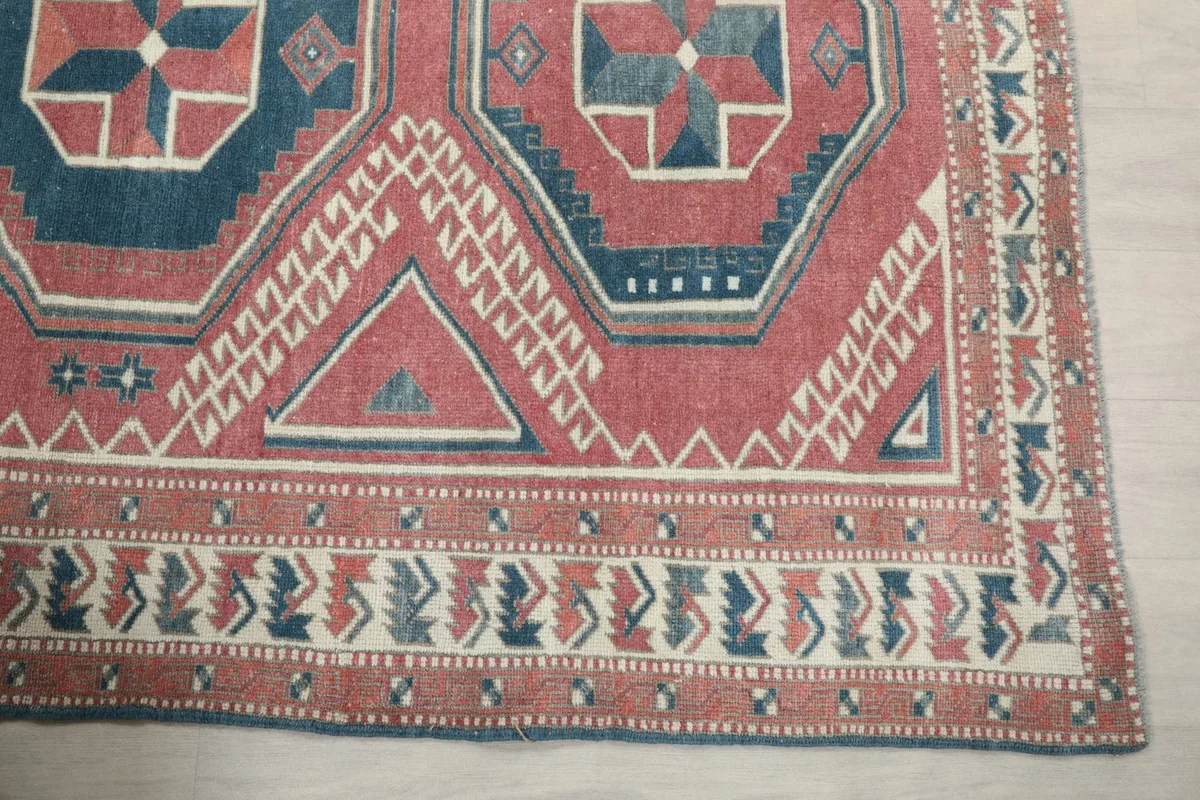Detailed view of the rug's corner with intricate tribal border designs