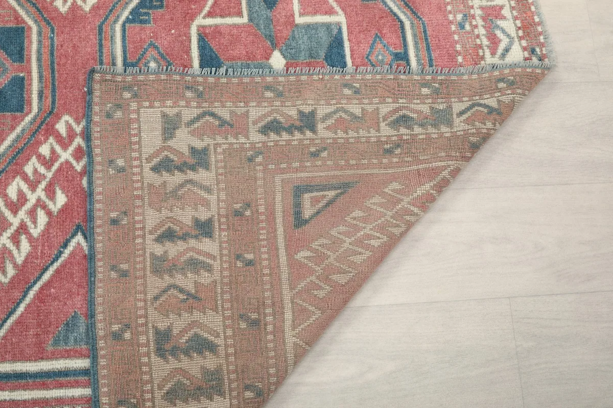 Another view of the rug's underside, showing the reverse of the border and knotting