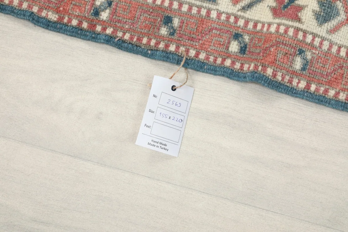 Close-up of the rug's edge with a product tag showing details like size and origin