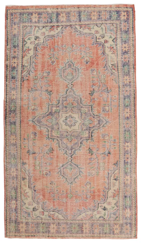 Full overhead view of the vintage rust and navy medallion rug