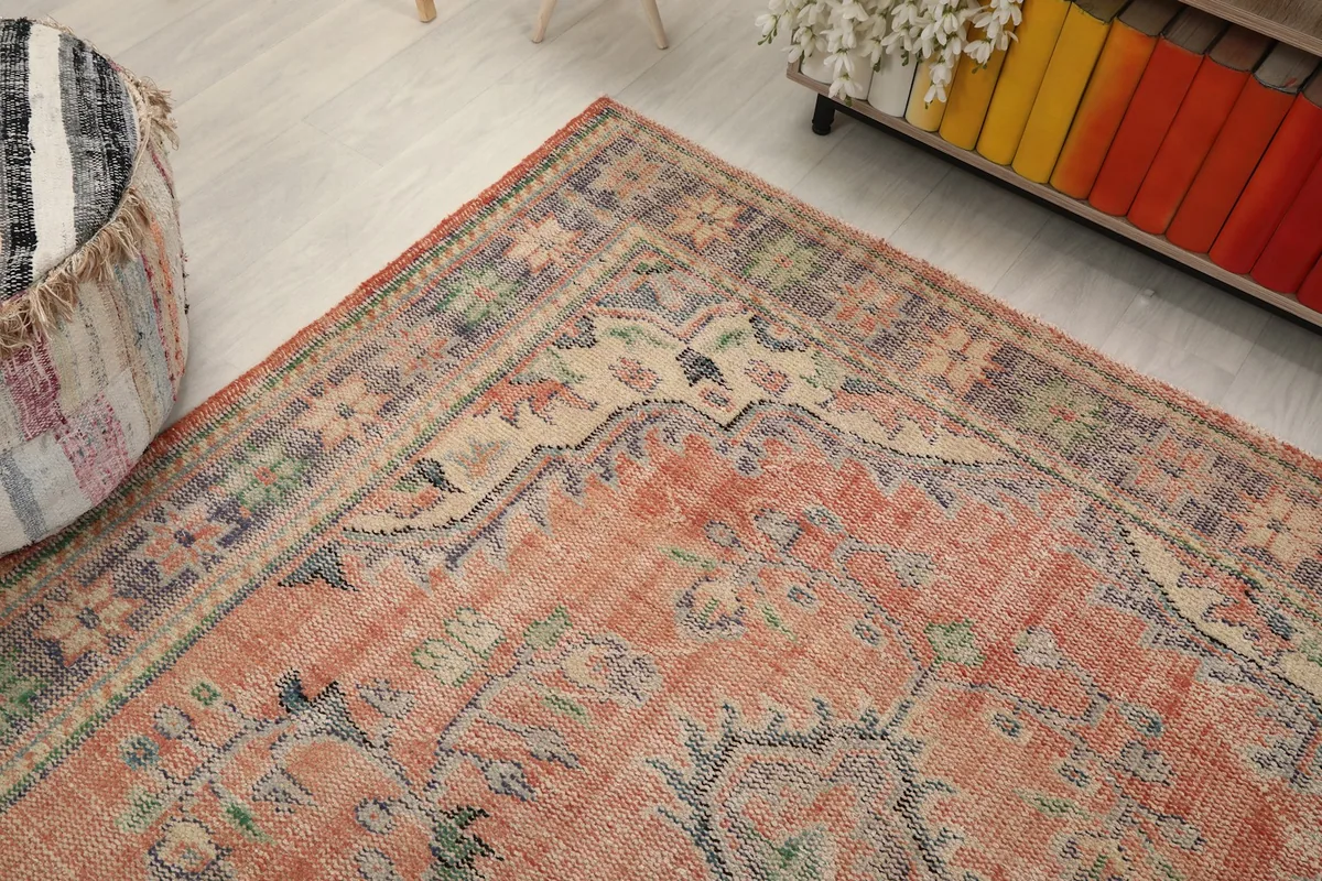 Top-down angle of the rug's upper corner, revealing intricate border designs