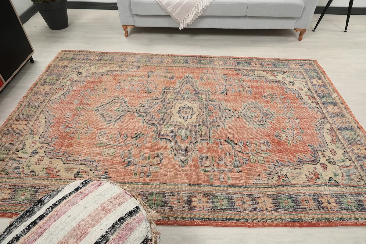 Wide shot of the rug in the room, showing its full design and color palette