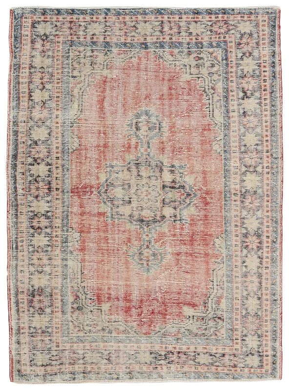 Full overhead view of the 4'8" x 6'4" vintage Anatolian rug with rose field and blue geometric medallion