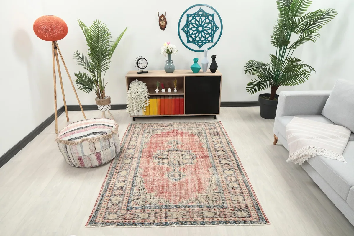 Vintage Anatolian rug in a living room setting, showing its size and colors with furniture