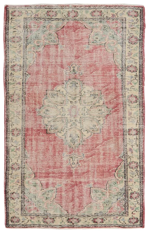 Full top view of the vintage Anatolian rug with a rose field and beige medallion on a white background