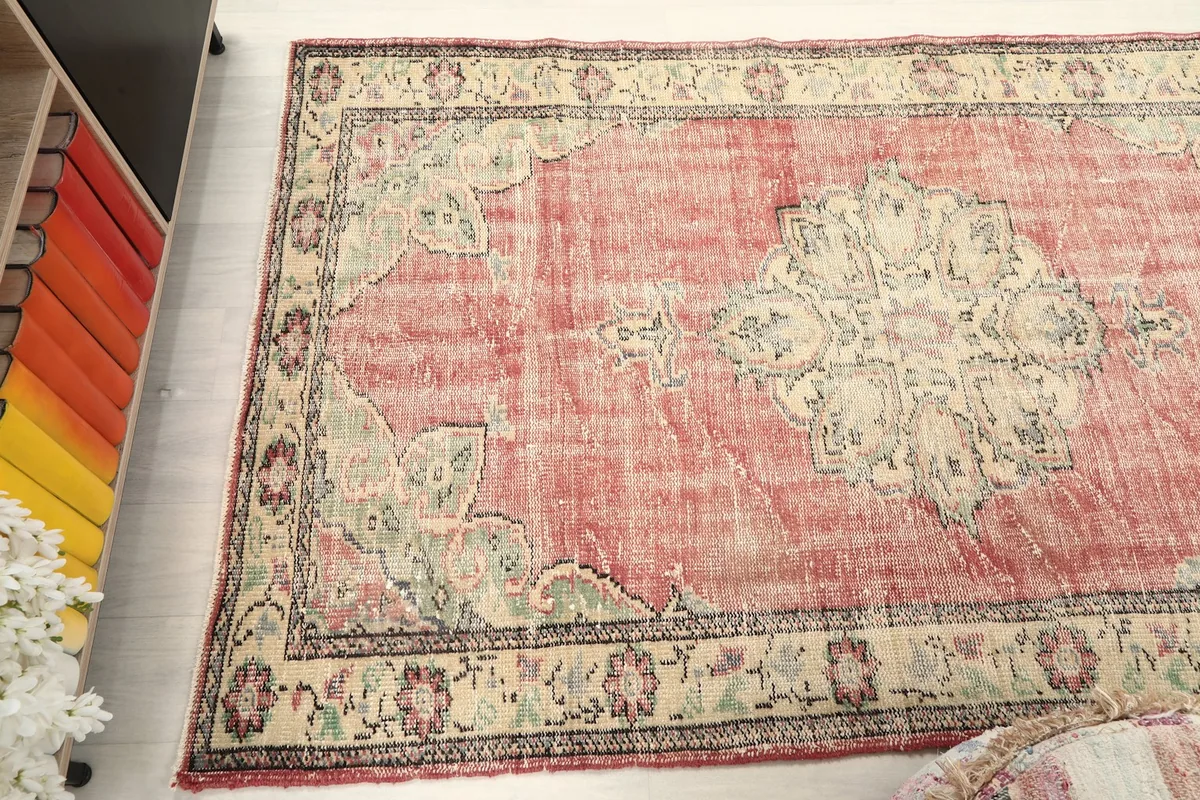 Wide angle shot of the rug on the floor, capturing the full pattern and color variations