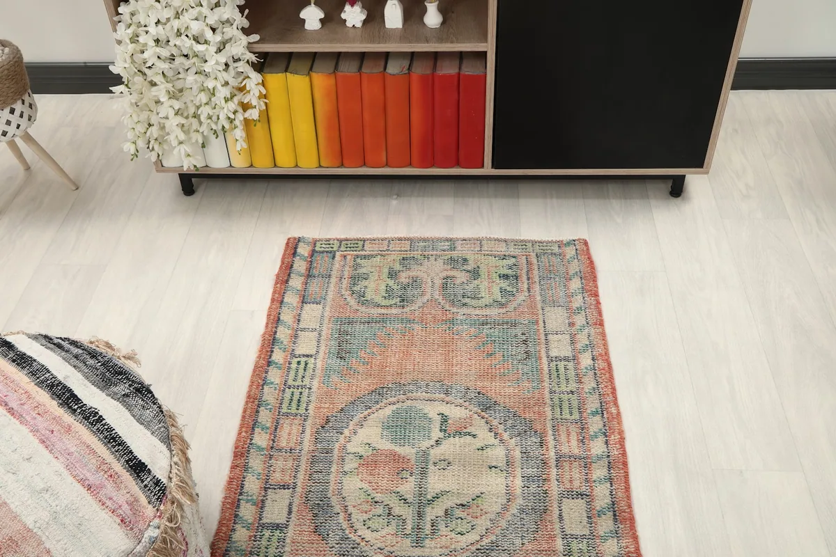 Overhead view of the vintage rug, capturing its full length in a room setting.