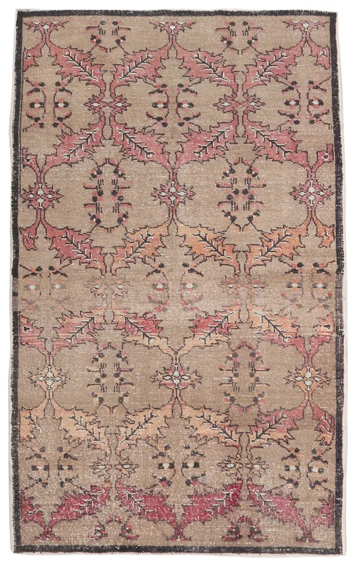 Full overhead view of the tan and rose geometric vintage Anatolian rug