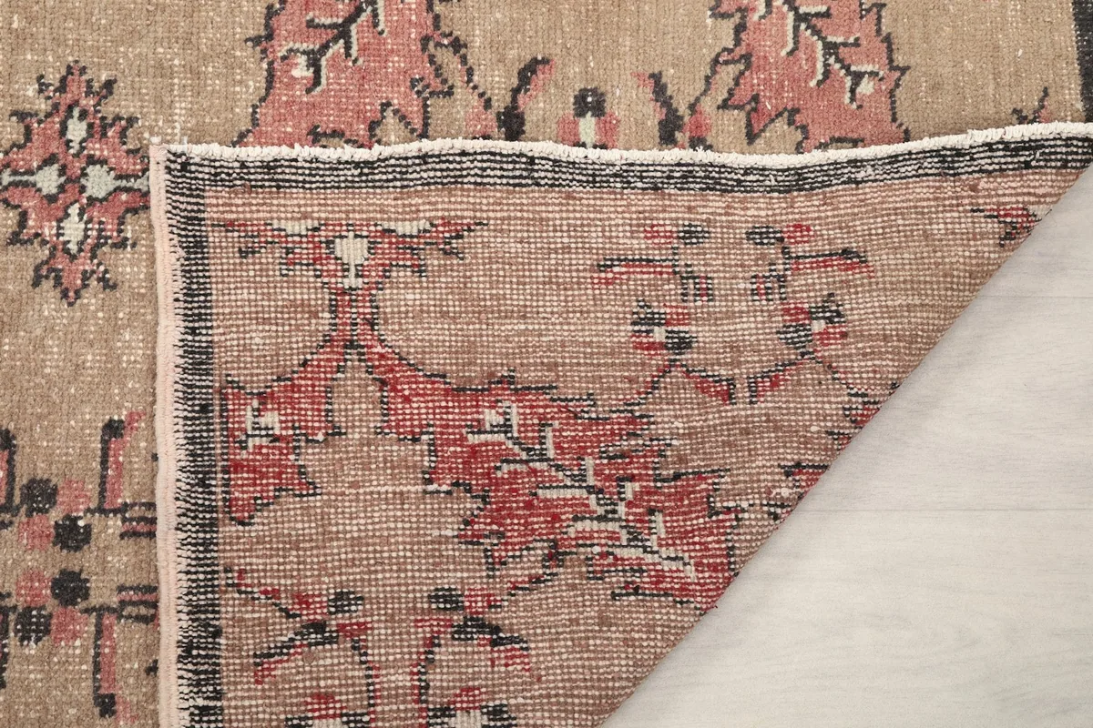 Underside of the rug, showing the cotton foundation and knotting