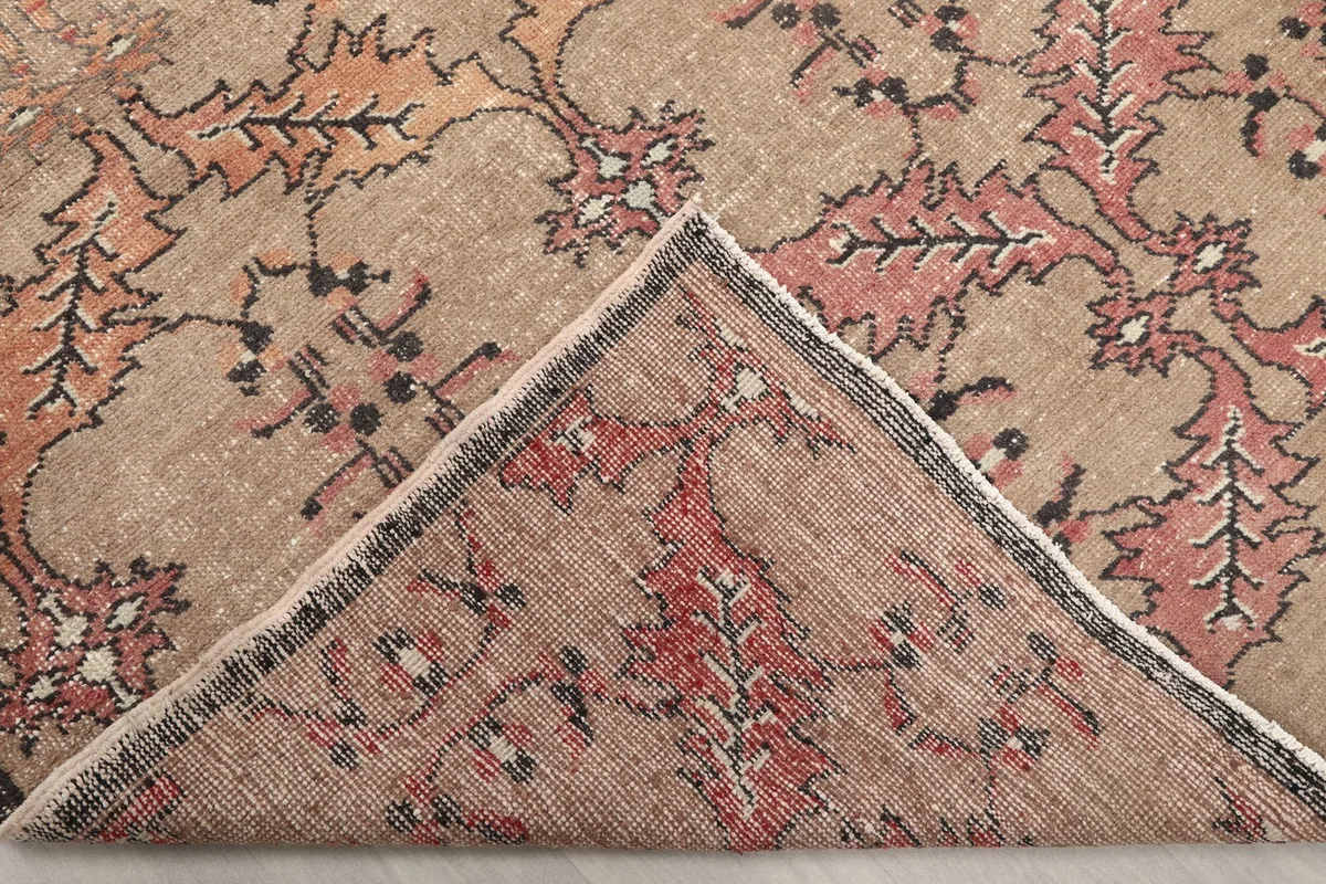 Folded corner of the rug, revealing the back of the hand-knotted wool
