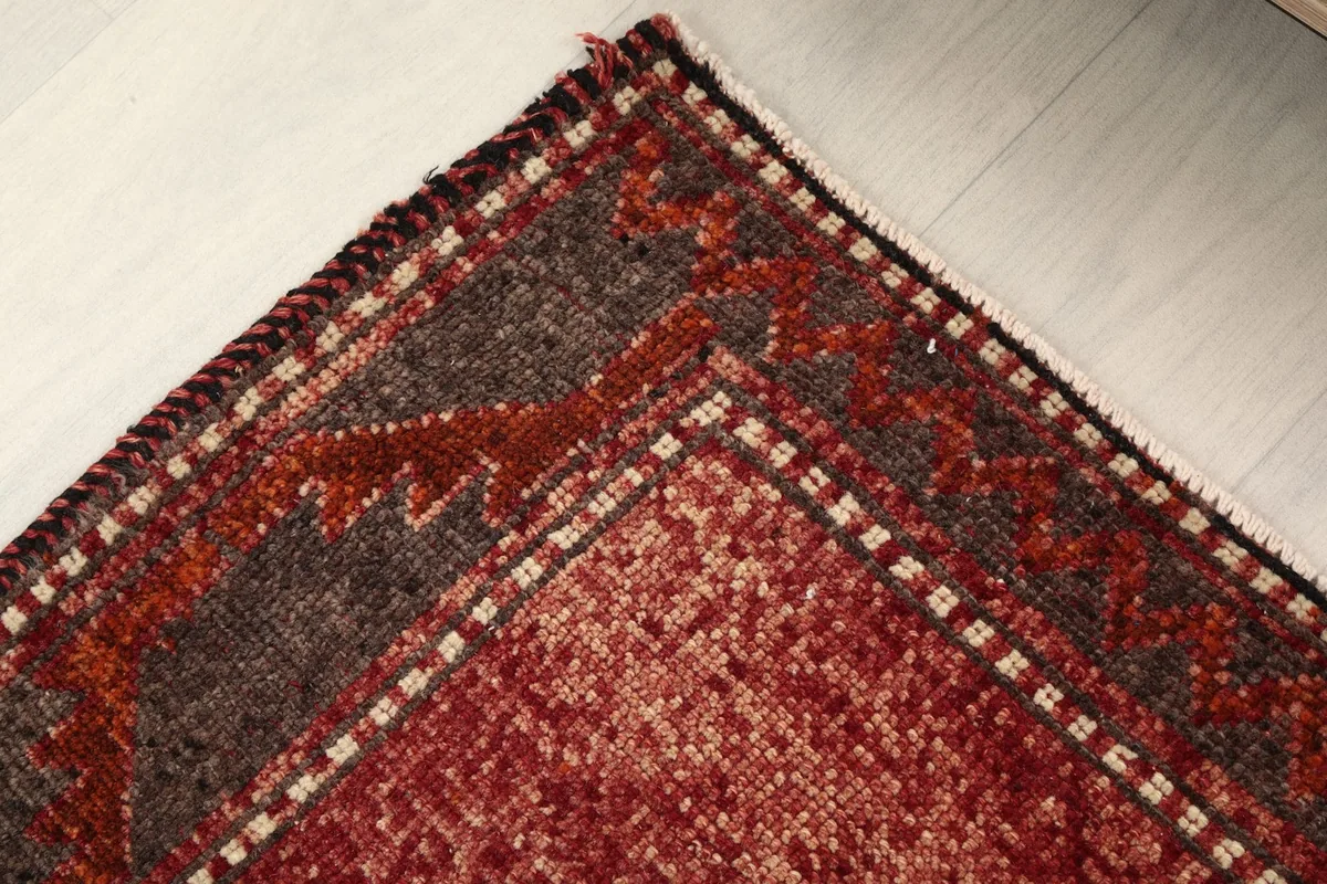 Detail of the rug's border design, showing the intricate patterns and color transitions