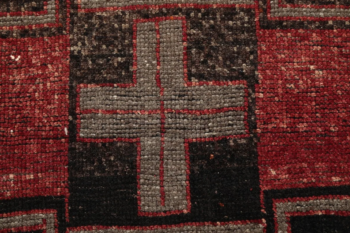 Macro view of the hand-knotted wool pile, showing texture and color variation within a motif