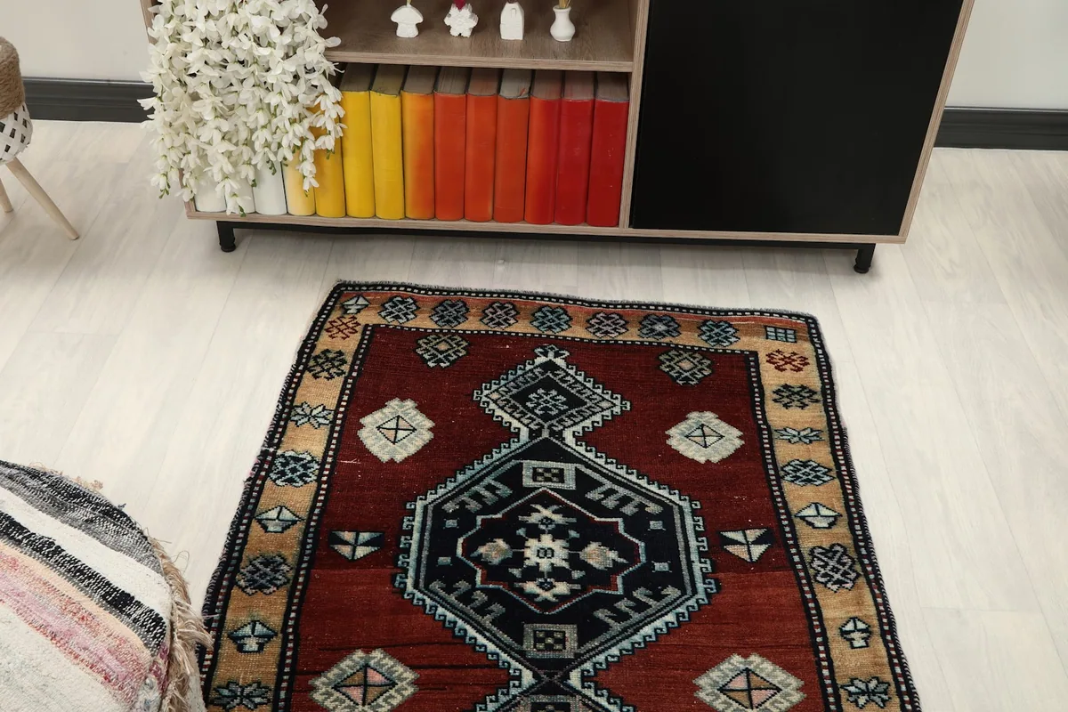 Angled view of the rust and navy rug from above, showcasing its design in the room setting.