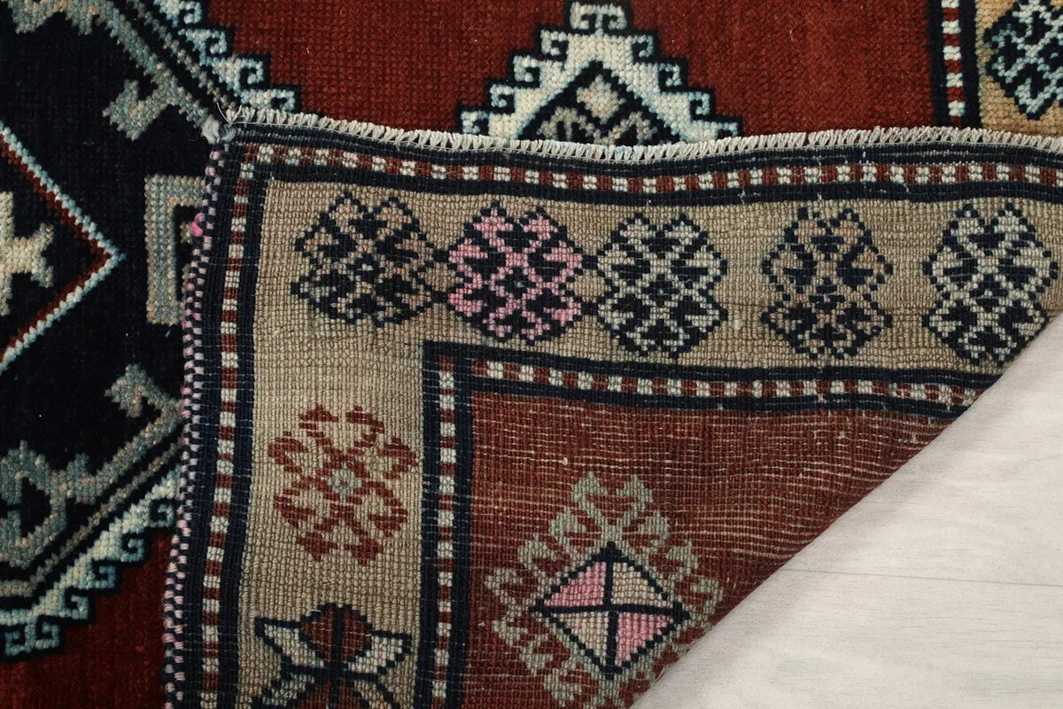 Partial view of the back of the hand-knotted rug, revealing the foundation and knotting structure.