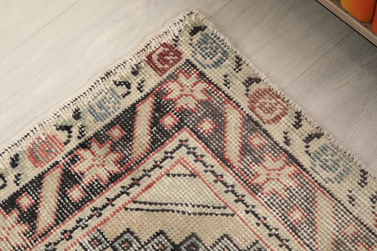Detailed view of the outer border design with floral and geometric elements