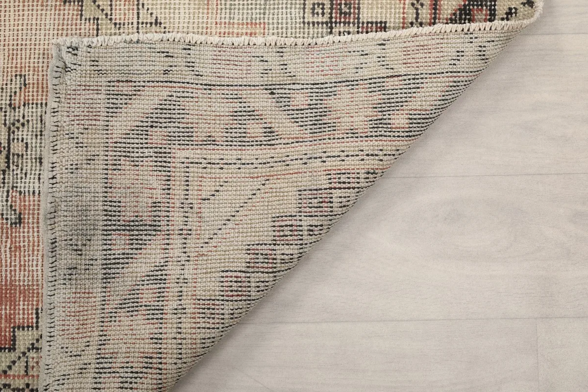 Underside of the rug, revealing the hand-knotted cotton foundation