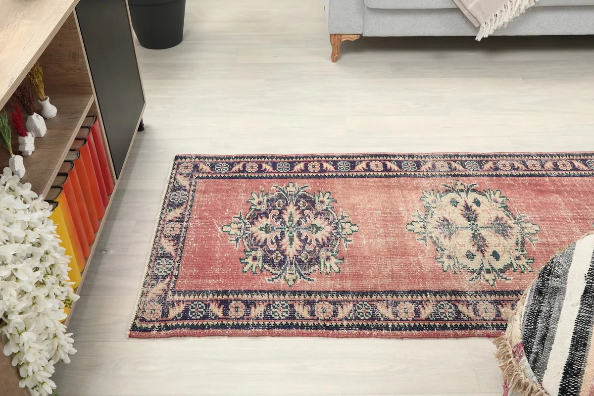 View of the runner rug stretching across a light-colored floor, with furniture in the background.