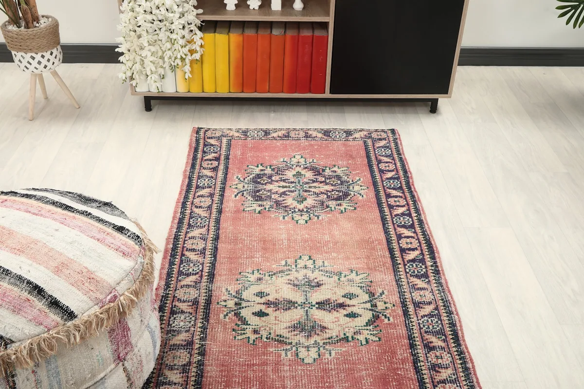 Overhead view of the rose runner rug in a room setting, focusing on the central medallions and border.