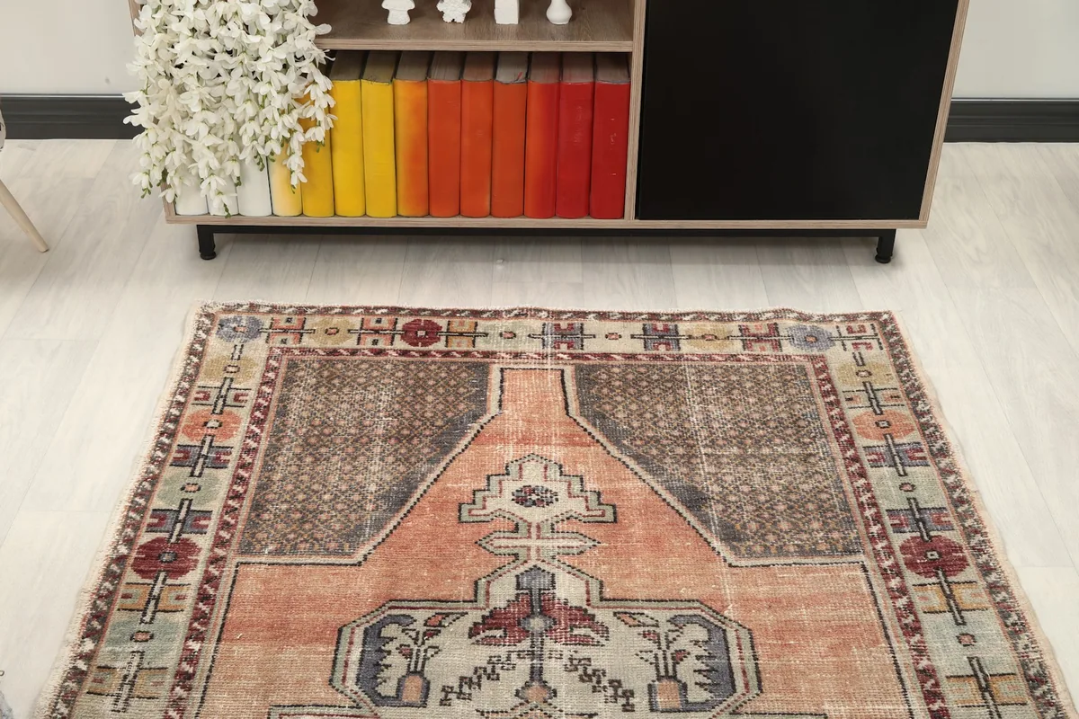 Overhead view of the rug in a room, showing its placement relative to a bookshelf