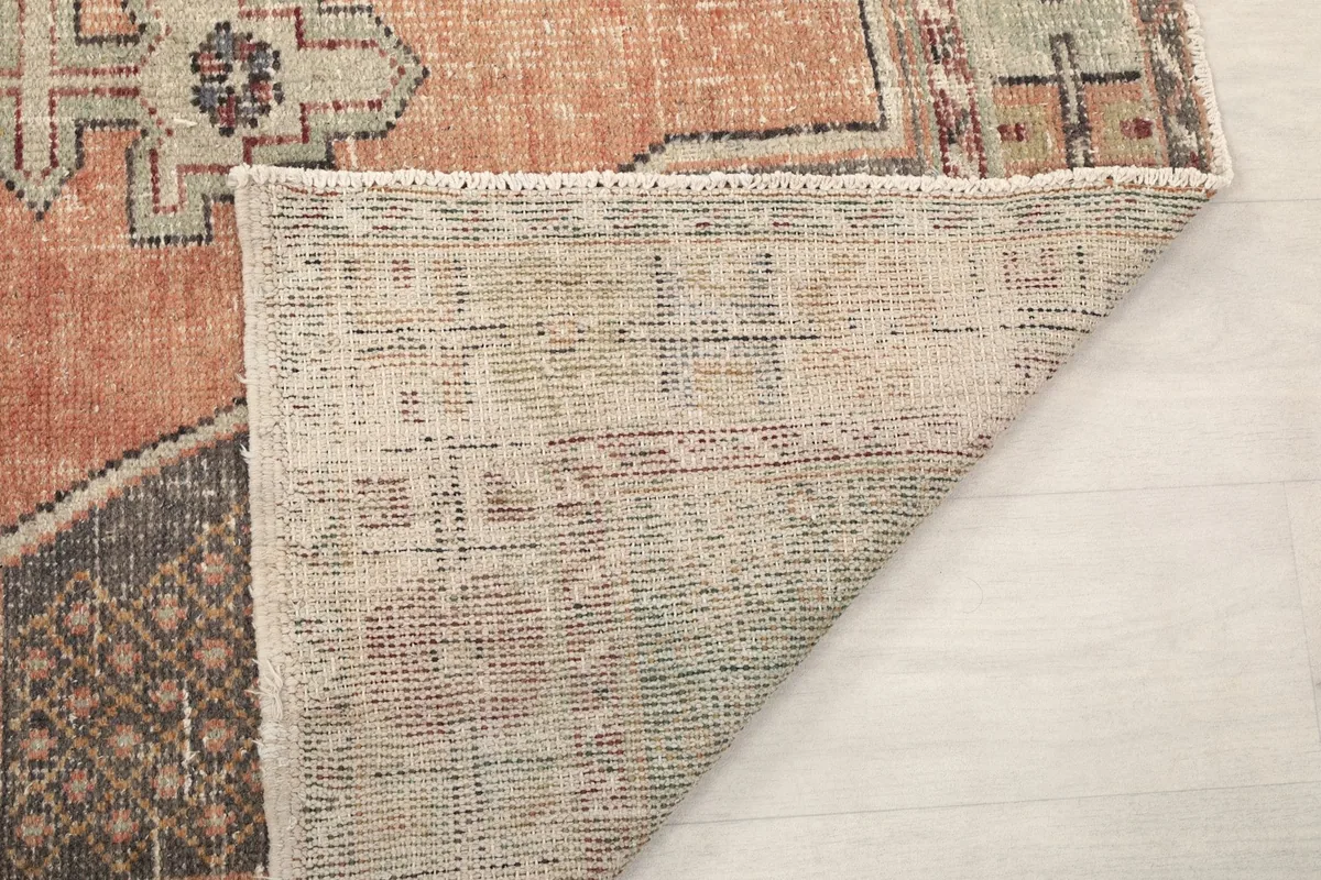 Another view of the rug's underside, showing the reverse of the hand-knotted wool pile